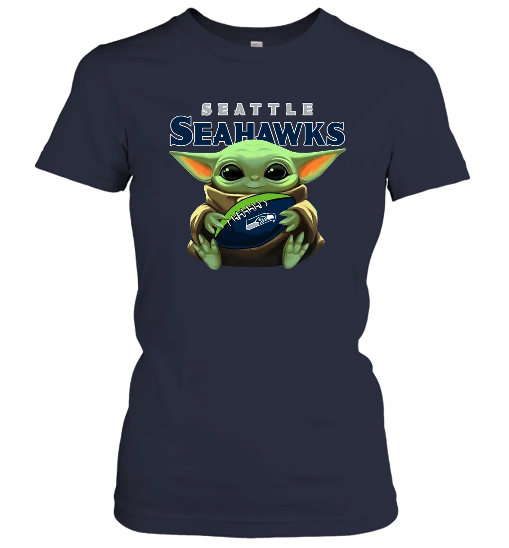 Baby Yoda Loves The Seattle Seahawks Star Wars Baby Yoda Hugs Seahawks NFL Womens T-Shirt